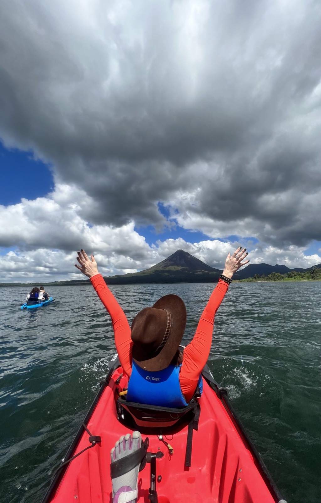 A boat on Lake Arenal with the volcano behind